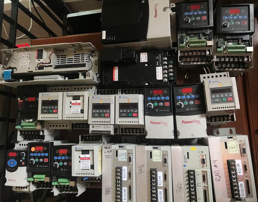 Allen-Bradley PowerFlex and Ultra 3000 drives sorted with handwritten NEW and BAD labels