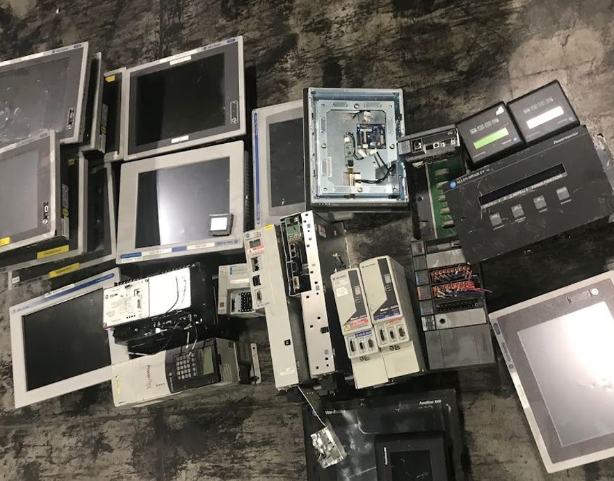 Used Allen-Bradley PanelViews, PowerFlex drives, and Kinetix servos laid out as surplus pulls